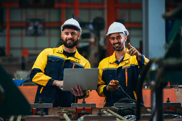 Portrait of industrial worker inspecting and check up machine at factory machines. Technician...