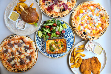 Table scene of assorted take out or delivery foods. Traditional Turkish cuisine. Various Turkish meal and appetizers. Top down view on a table.