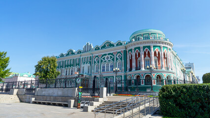 Sevastyanov's House or House of Trade Unions on shore of city pond formed by dam on Iset River. Historical and architectural monument located in Yekaterinburg, Russia