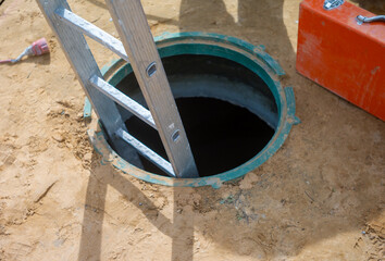 open manhole and ladder