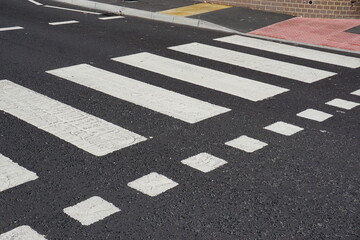 zebra crossing point on UK road. painted road crossing markings. pedestrian safety 
