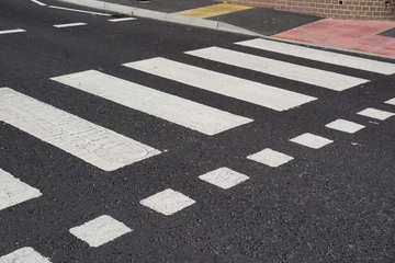 Deurstickers zebra crossing point on UK road. painted road crossing markings. pedestrian safety  © Paul Cartwright