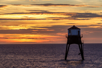 sunrise over a old lighthouse in the sea, Dovercourt low lighthouse, built in 1863 and discontinued...