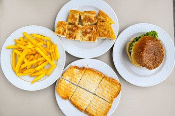 Table scene of assorted take out or delivery foods. Traditional Turkish cuisine. Various Turkish meal and appetizers. Top down view on a table.