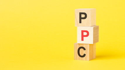 wooden blocks with the text PPC on a bright yellow background