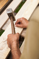 Carpenter working with wooden board