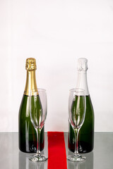 Two bottles of champagne with two crystal glasses.