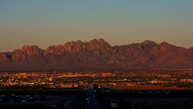 a sunset over Las Cruces, New Mexico with a the organ mountains in the background