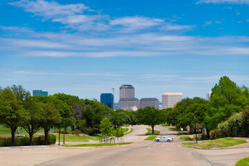 cityscape and road way with no cars. empty road with destination in horizon. road way with power lines. travelling by road way