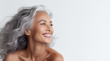 Black adult woman touch face with smooth healthy skin. Beautiful aging mature woman with long gray hair and happy shy smiling. Beauty and cosmetics skincare advertising concept, white background
