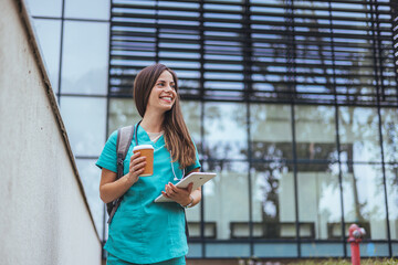 Woman caregiver, nurse or healthcare worker outdoors on the way to work. Nurse standing outside to...