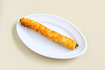 Turkish style meat stuffed filo dough borek served kol boregi. Cheese and minced pie are sliced on a marble background. Turkish name: Kol Boregi, ispanakli, kiymali, Su Boregi