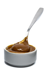 Dulce de leche in a small bowl on isolated background.