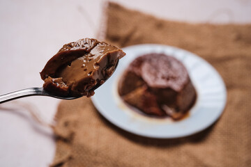 Close-up of a spoonful of delicious coffee flan, highlighting its texture