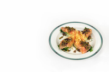 gourmet food, salmon with mushrooms, olives and fine carrot zest, isolated on white background and space for text or design