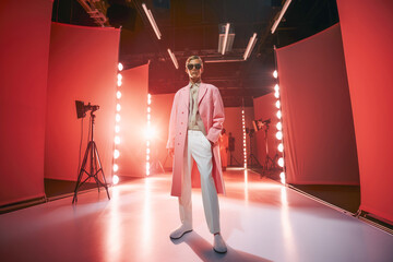 Event Spotlight: The stage is set, and the runway is illuminated as a model confidently displays a designer's creation during a glamorous fashion event.