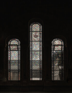London,UK - Nov 1, 2023 - Coriander stained glass on the elevation windows are contained within large stone arches in the main hall of The natural history museum. Pattern of The Stained glass windows.