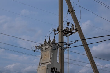 Fototapeta na wymiar Power line poles and wires with a transformer. Distribution panel.