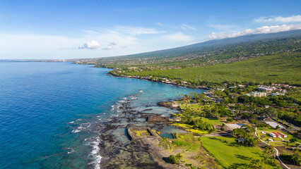 Drone photos off the the Big Island, Hawaii along the coast line with a beautiful blue sky and water