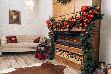 Cozy apartment, artificial electric bright fireplace with fake sparkling flame. Christmas Tree gifts presents garlands, decorated toys balls interior New Year


