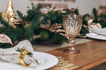Cozy flat apartment photo studio room green Christmas Tree gifts presents garlands, candles decorated dinner table settings toys balls interior New Year lights glowing bokeh

