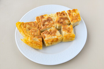 Turkish style meat stuffed filo dough borek served kol boregi. Cheese and minced pie are sliced on a marble background. Turkish name: Kol Boregi, ispanakli, kiymali, Su Boregi