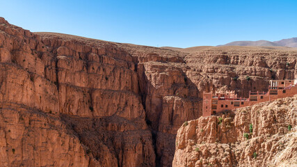 Hotel at the top of Dades Gorges, a series of canyons formed by the Dades River. Red and orange rock formations create a dramatic and picturesque landscape.