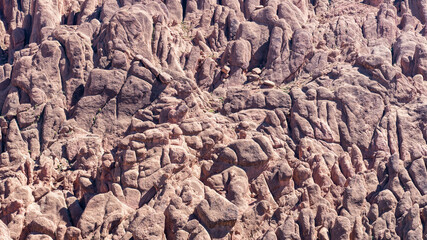 Rock formations in Dades Gorges, a series of canyons formed by the Dades River. Red and orange rock formations create a dramatic and picturesque landscape.