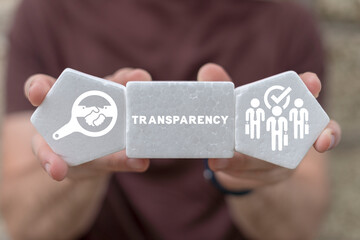 Man holding white styrofoam blocks sees word: TRANSPARENCY. Concept of business transparency. Honest and clean company. Financial and economical stats sharing, publication and presentation.