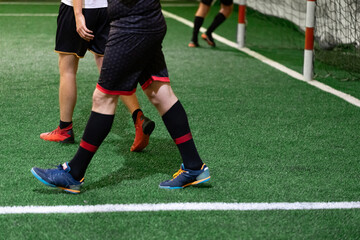 Obraz premium Minisoccer players on court during the match. Space for copy.