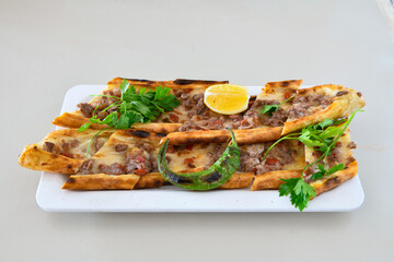 Kiymali pide.Turkish pide with minced meat. Turkish pizza mince pita Pide on white background. Etli ekmek. Kusbasi kasarli, kiymali kasarli, kiymali yumurtali,  tirnak Trabzon, Bafra, Kusbasili pide.