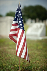 American flag flying in cemetery on Memorial Day 