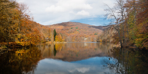 Snina Rock and it's reflection in Morske oko lake in the Vihorlat Mountains, Slovakia
