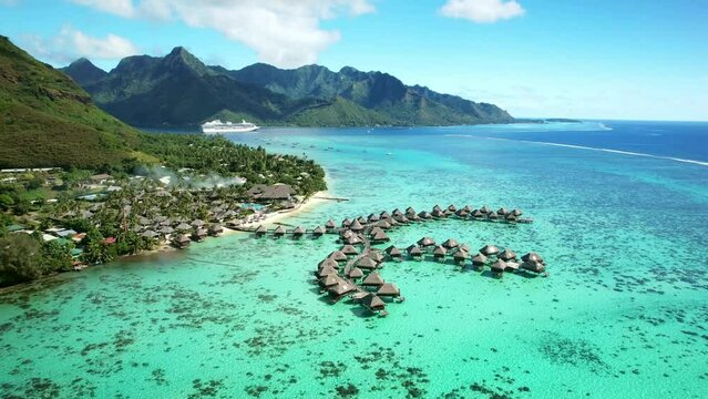 Drone Tahiti. Aerial view of overwater bungalows in coral reef lagoon ocean. Luxury honeymoon vacation, romantic getaway. French Polynesia.