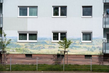 lovely rural German landscape mural on a high-rise building in silicate paint, with layers of soil with underground animals