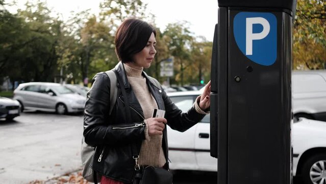 Woman Pays For Car Parking Via Parking Meter Using Credit Card
