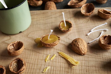 Handmade production of Christmas candles from nut shells