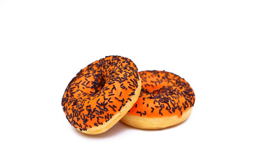 two bright orange donuts with chocolate sprinkles isolated on a white background