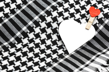 Free text space in the shape of a heart on a traditional head scarf keffiyeh used in the Middle East and the Arab world.