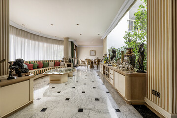living rooms with perimeter sofa and staircase area of a luxury house with polished marble floors,...