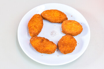 Fried Chicken breast hot crispy strips crunchy chicken tenders  isolated on white background.Nuggets isolated on white background on a plate