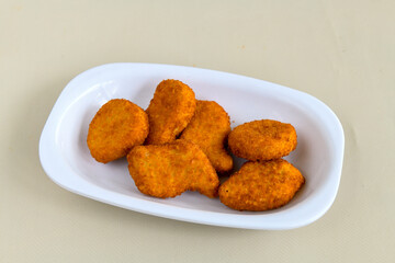 Fried Chicken breast hot crispy strips crunchy chicken tenders  isolated on white background.Nuggets isolated on white background on a plate