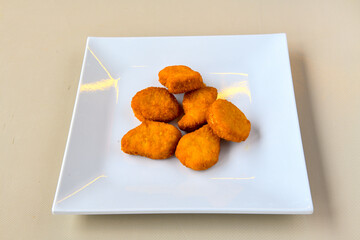 Fried Chicken breast hot crispy strips crunchy chicken tenders  isolated on white background.Nuggets isolated on white background on a plate