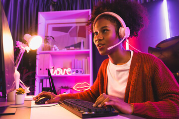 Host channel of gaming streamer, African girl wining with Esport skilled team player and viewers online game in neon color lighting room. Concept of cybersport indoor activities. Tastemaker.