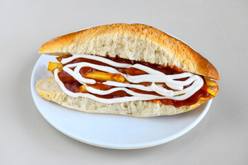 Close-up shot of Izmir's famous Turkish Traditional Kumru Sandwich, Çeşme Kumru , ingredients ready to eat salami, sucuk , tomato, cheddar cheese and fried cheese. Yengen eritme karisik sandvic.