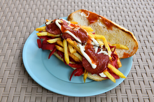 Close-up shot of Izmir's famous Turkish Traditional Kumru Sandwich, &Ccedil;eşme Kumru , ingredients ready to eat salami, sucuk , tomato, cheddar cheese and fried cheese. Yengen eritme karisik sandvic.