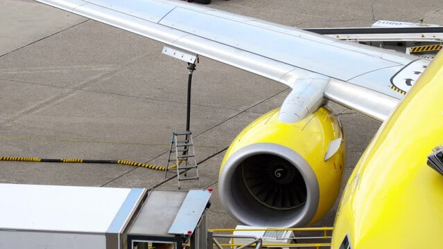 DUSSELDORF, GERMANY - JULY 23, 2017: Footage of an airplane refueling. View from the terminal window of a TUI Fly passenger plane, pre-flight service
