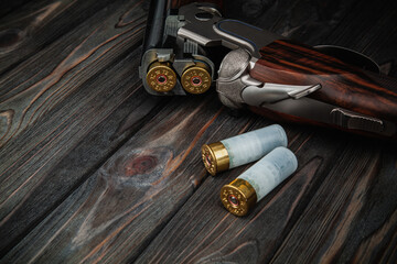 Classic trigger double-barreled hunting rifle on a wooden background. Concept postcards for...