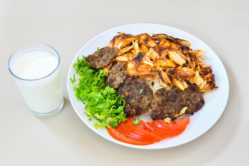 Beef steak grill with rice pilaf, fried potatoes, grilled pepper and tomatoes.Mix Platter with Beef rips, Cutlets, Potatoes and Sauces.