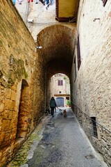 narrow street in the town , image taken in san gimignano, tuscany, italy - 674139702